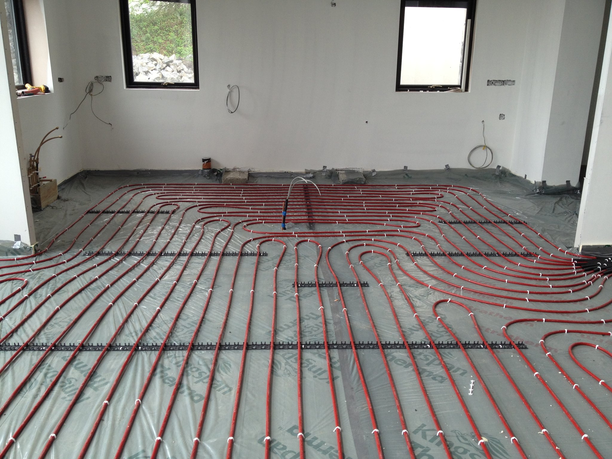 Underfloor heating pipes laid out on a floor