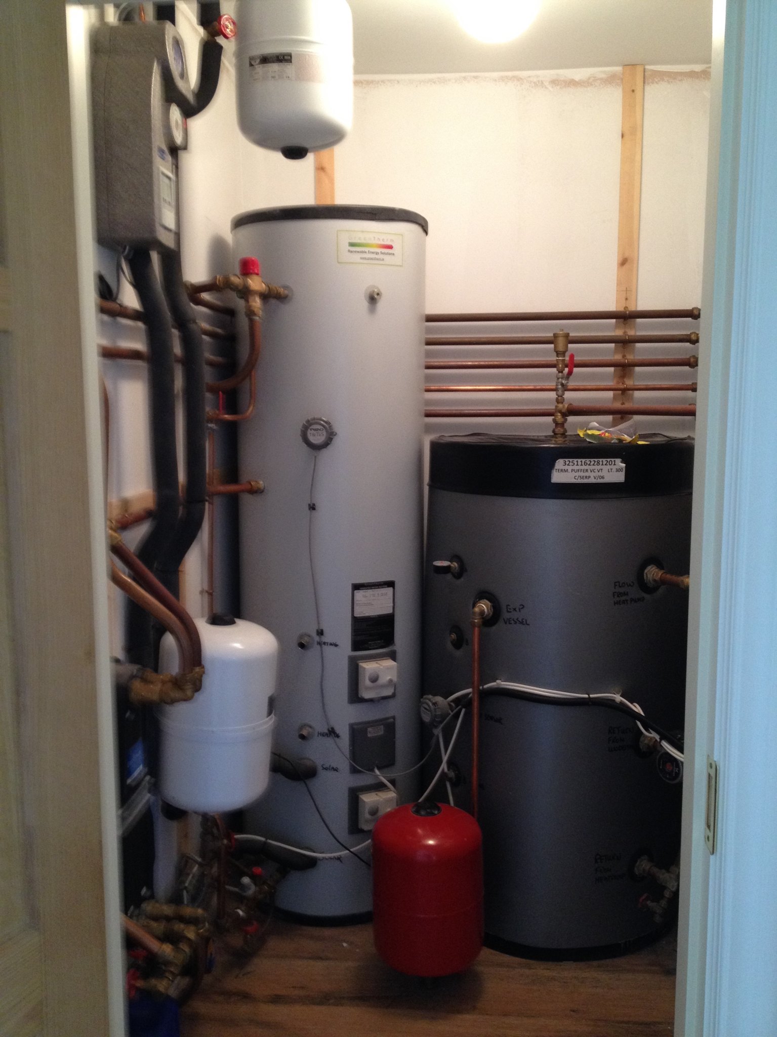 Hot water cylinder and pipework in a hot press