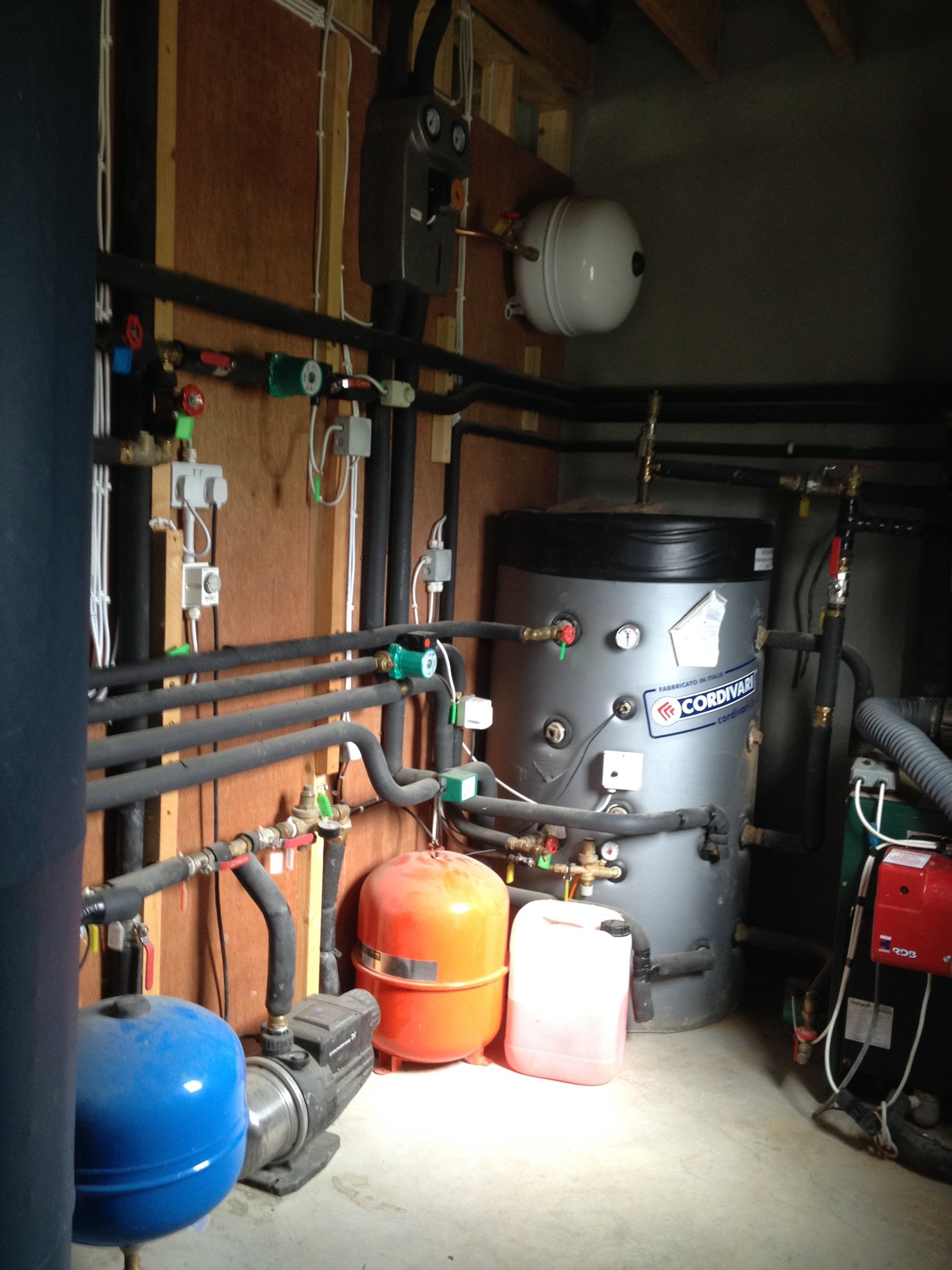 Plant room with a buffer tank, expansion vessels and insulated pipework