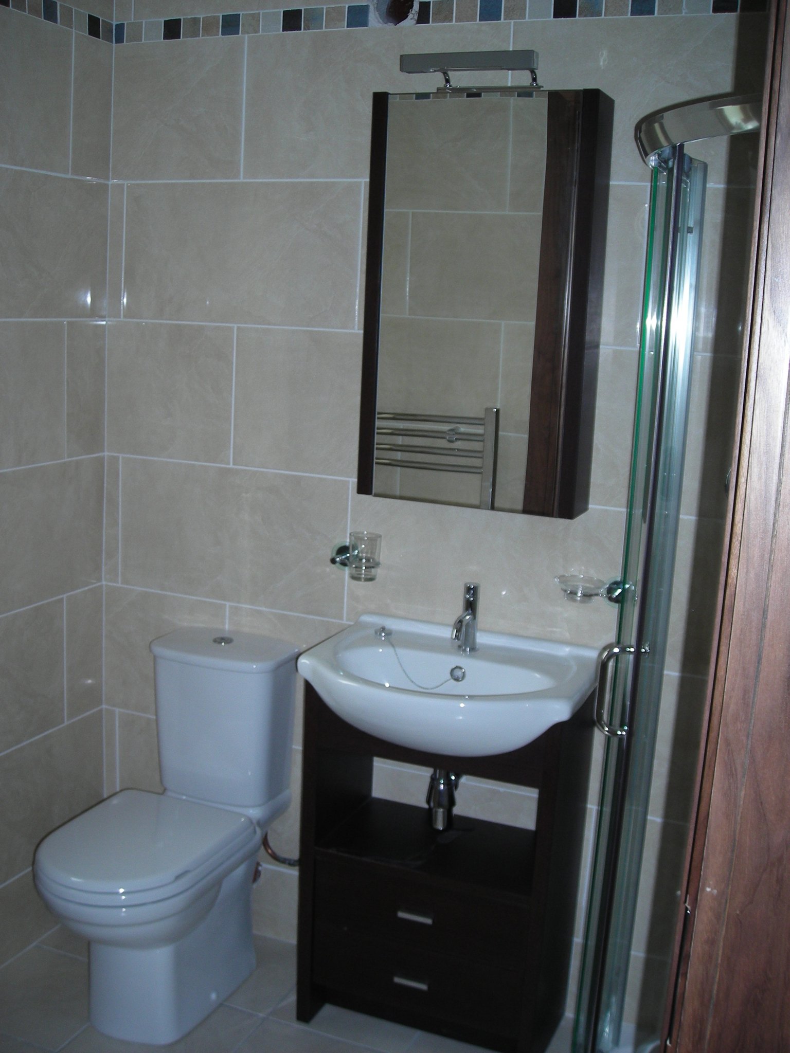 Bathroom with a vanity unit, mirror cabinet and shower
