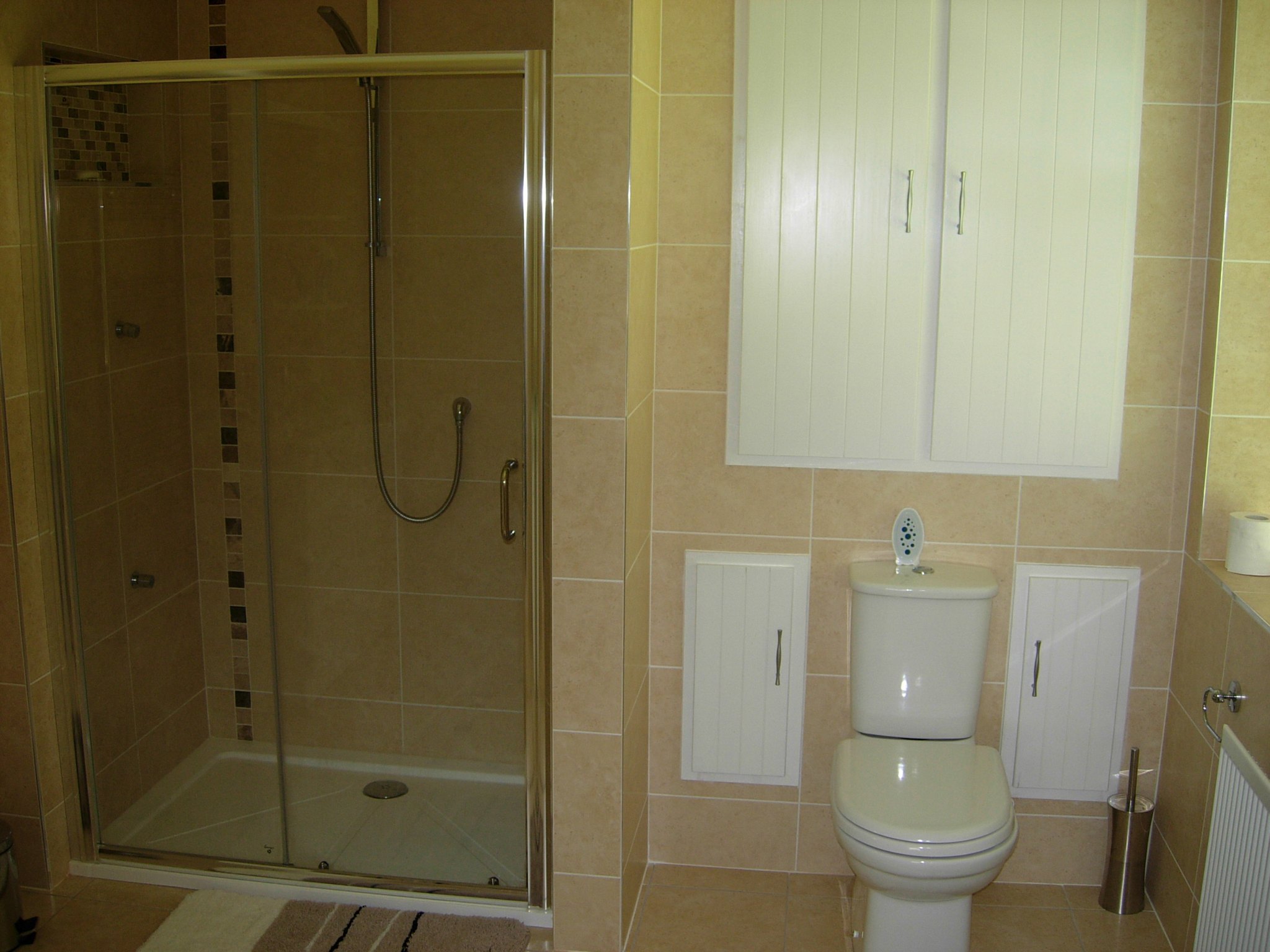 Bathroom with a shower enclosure, toilet and fitted cabinets