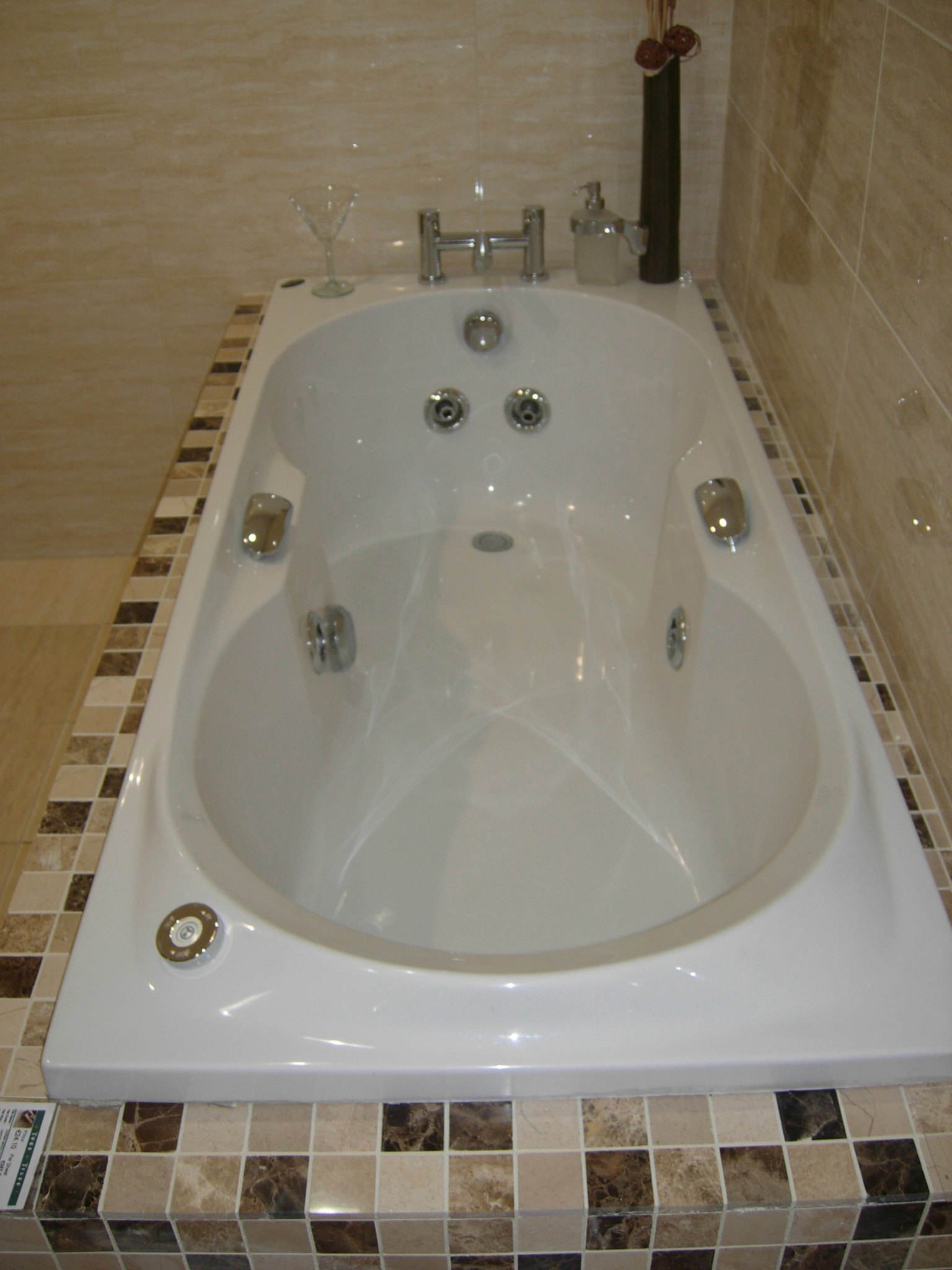 Whirlpool bath set in a mosaic tile surround